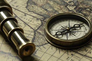 Retro compass with old map and spyglass