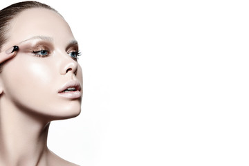Fototapeta premium Beautiful woman portrait with white skin, fashion make up and with hand touching her eye.