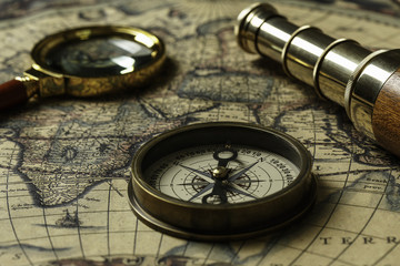 Retro compass with old map and spyglass