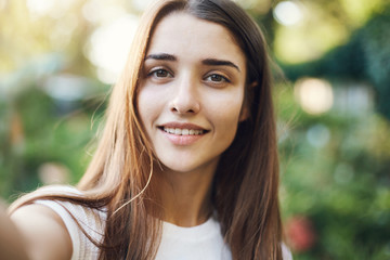 Obraz premium Portrait of young woman gardener taking a selfie