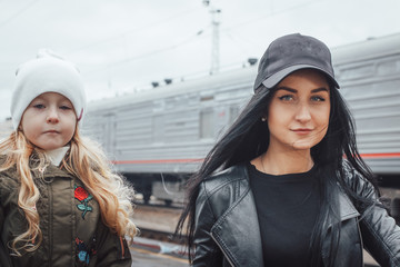 Mother and daughter at the train station