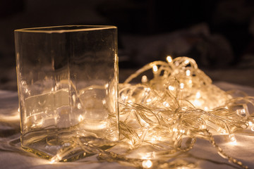 glass cup with LED light bulb wire in background