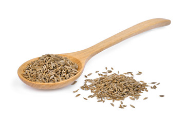 dried cumin seed or caraway in wooden spoon isolated on white background