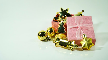 A christmas props : santa claus, ornament and a present box on a trolley against an isolated white background with a copy space. Concept for Christmas celebrations.