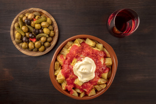 Tapas and wine. Patatas bravas, olives, and copy space