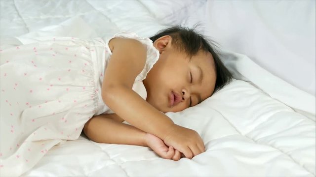 4k of lovely baby sleeping in white bed