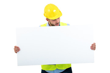 Happy male engineer holding an advertisement blank banner. Isolated on white background