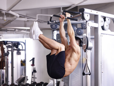 asian bodybuilder exercising in gym