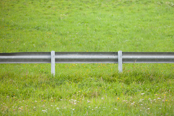 secondary road guardrail in a mountain pasture