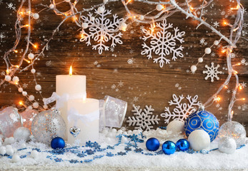 Christmas candles with Christmas ornaments and Christmas lights.