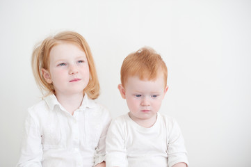 Red-haired brother and sister in white clothes