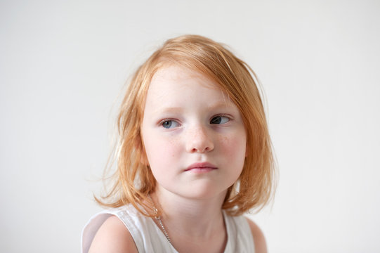 Portrait of a cute red-haired girl in a white T-shirt
