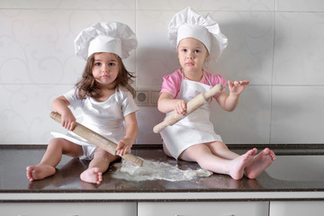 Funny kids are preparing the dough in the kitchen. happy family