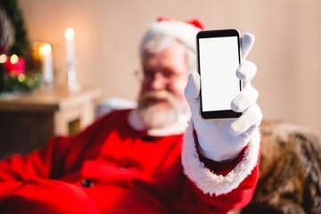 Santa claus sitting and showing his smartphone