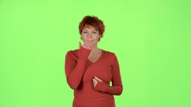 Woman sends kisses to others. Green screen