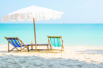 Colorful chairs and White umbrellas on the beach at Samed Island, Thailand.