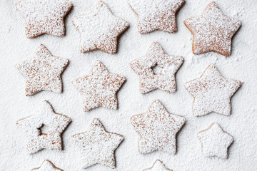 Christmas preparations star shaped gingerbread cookies with snowy sugar coating