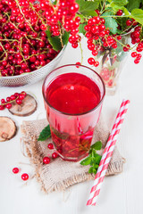Morse from red currant (juice, compote) on a light background.