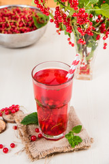 Morse from red currant (juice, compote) on a light background.