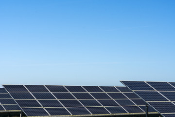 Commercial solar panels on bright day in the English countryside