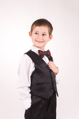 A boy posing in studio over grey background 