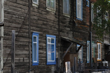 winter in the border village of sibiria wooden house with many colored windows