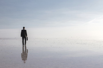 Man in black suit on salt lake