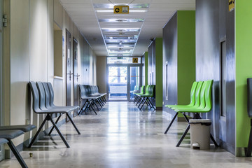 Corridor with chairs for patients in modern hospital