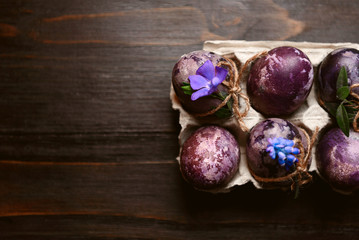 Fototapeta na wymiar Expensive marble Easter eggs on a wooden background