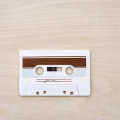 Vintage audio cassette tape with jazz music on wooden background