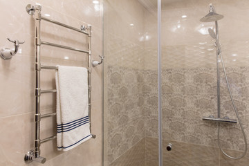 shower after  glass and  towel on dryer in bathroom