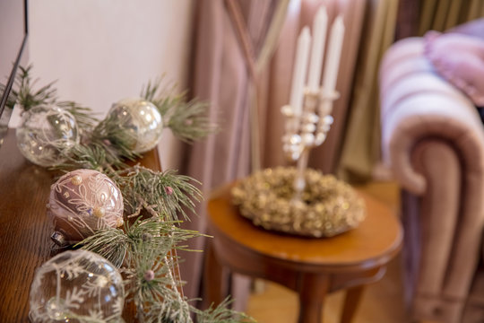 Christmas balls on wooden shelf on  background of  candlestick