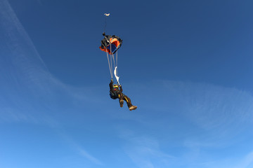 Fototapeta na wymiar Skydiver is opening a parachute.