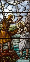 Casorate Primo, Italy. October 26 2017. Stained glass depicting the baptism of Jesus Christ by John the Baptist. San Vittore Martire Church (Church of Saint Victor Maurus or the Moor the martyr)