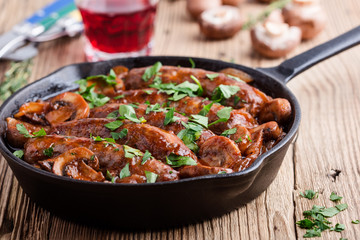 Sausages with onion and mushrooms gravy