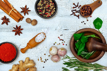 Spices and herbs on white wooden background