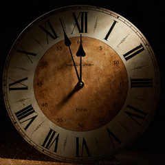 New Year Card with a vintage clock before midnight