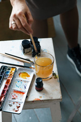 Set of watercolor paints often used by professional artist. Realistic image with spots, blots and traces of use. Natural light. Vertical composition