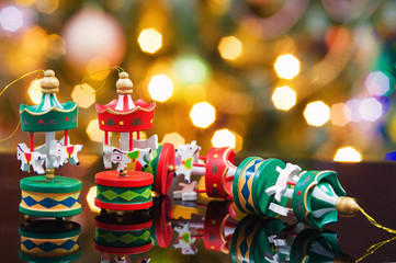 Christmas ornaments and Christmas trees. Colorful stars and more.Little boy is playing on the bed with a book .