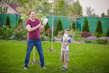 Dad and son playing at home garden