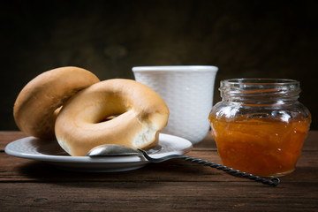 Jam jar and pretzel on the table close-up