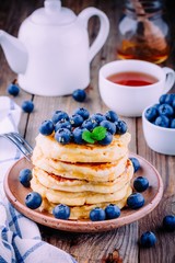Delicious pancakes with fresh blueberries and honey