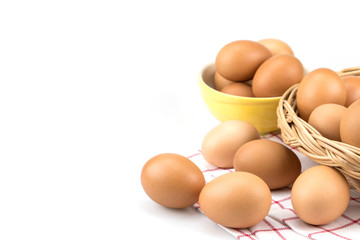 Eggs on cloth with mini basket in the background , isolated on white background