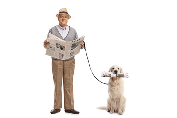 Senior holding a newspaper and a labrador retriever dog with a newspaper