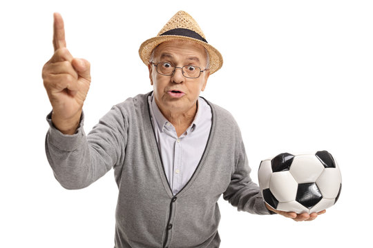 Angry senior with a deflated football arguing and gesturing with his finger