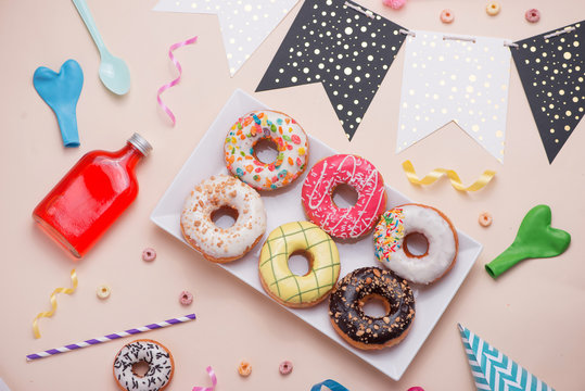 portrait of some donuts on plate for child's party on birthday table set