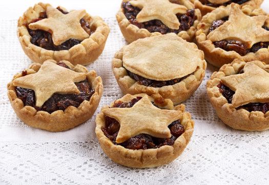 Traditional homemade fruit mince pies on white.
