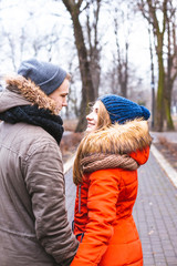 Couple in love walking in winter park and enjoy each other's company