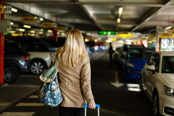 Young woman with travel bag and walking at the parking airport ready for travel. concept. lifestyle