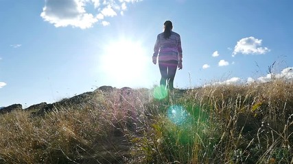 Low angle of woman on top of mountain at Sunset Hiker Girl celebrating life scenic nature landscape enjoying vacation travel adventure